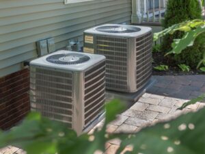 Two air conditioners outside of a home