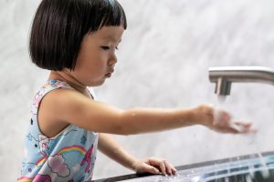 Little girl washing her hands