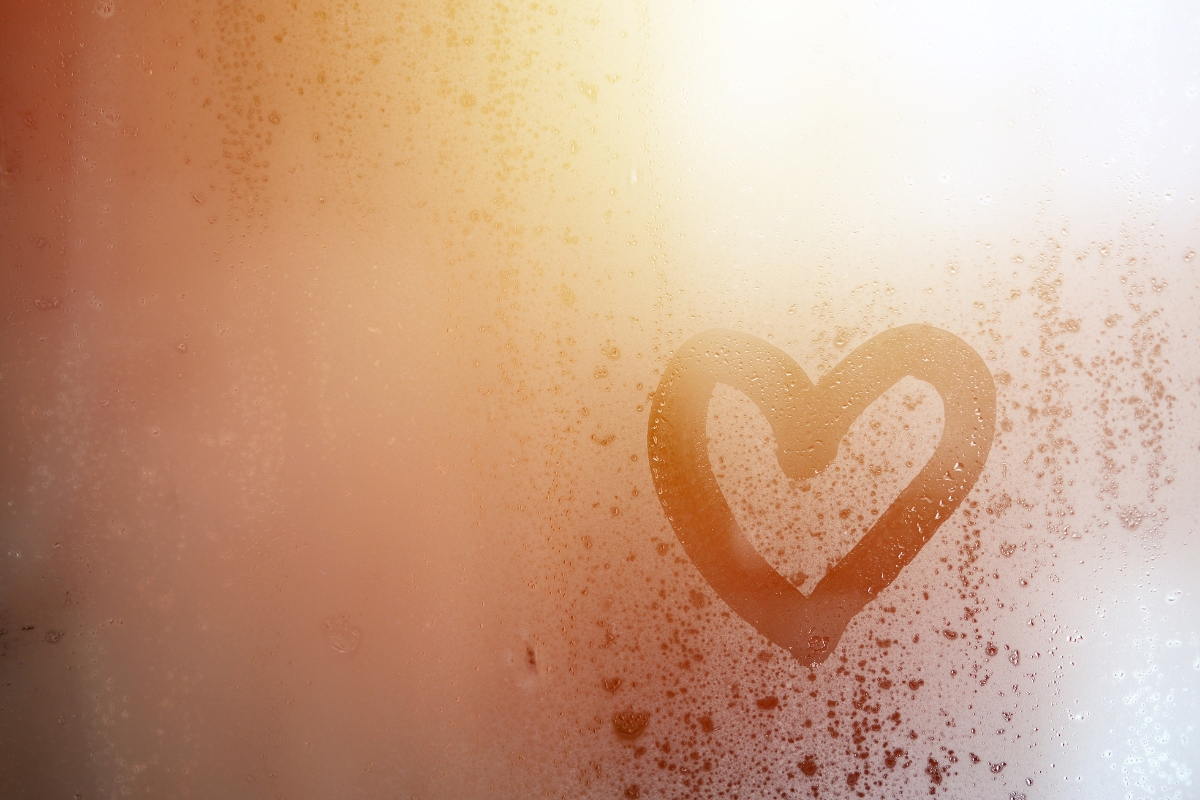 Small heart drawn in condensation on a shower door