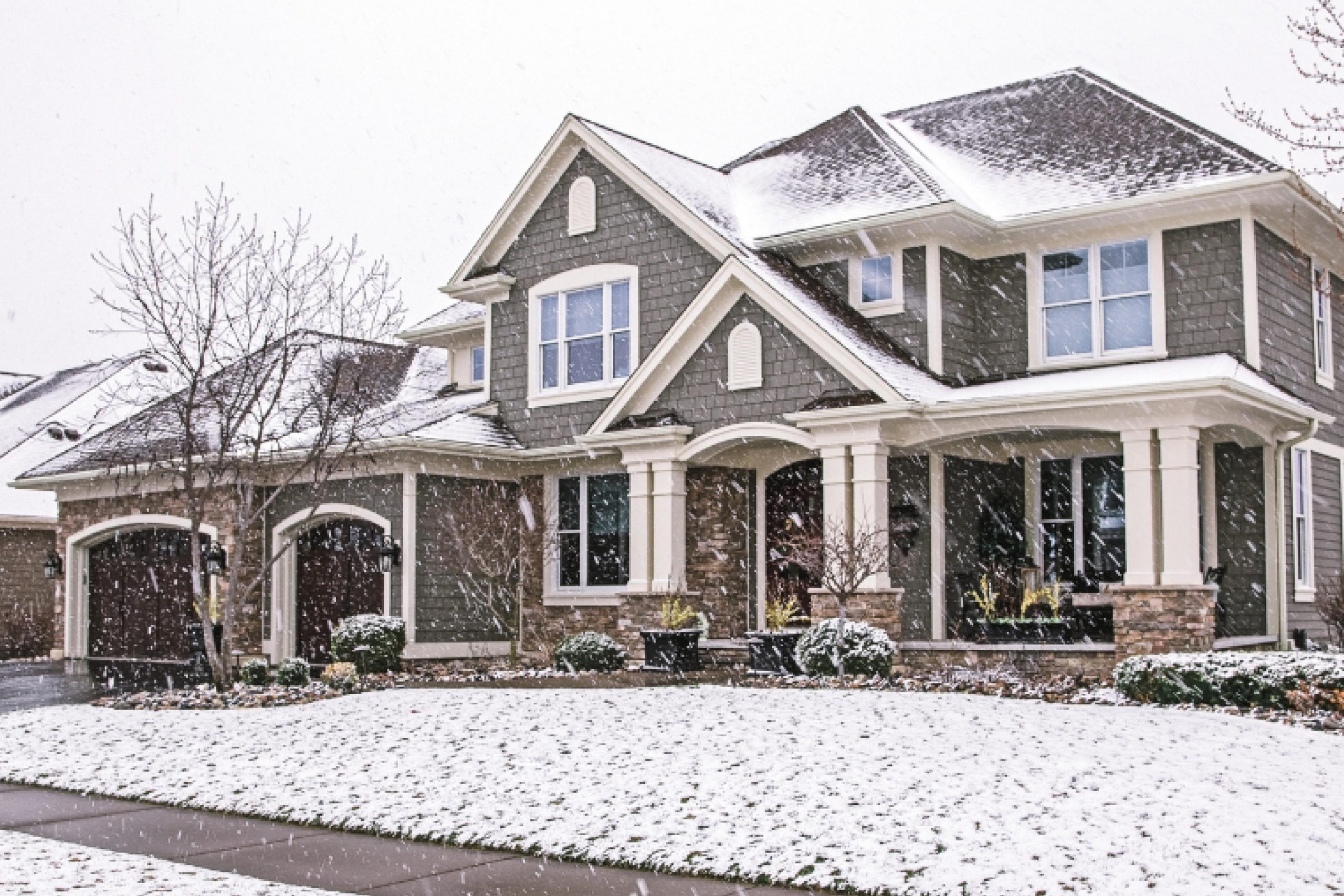 Two-story home exterior covered in snow