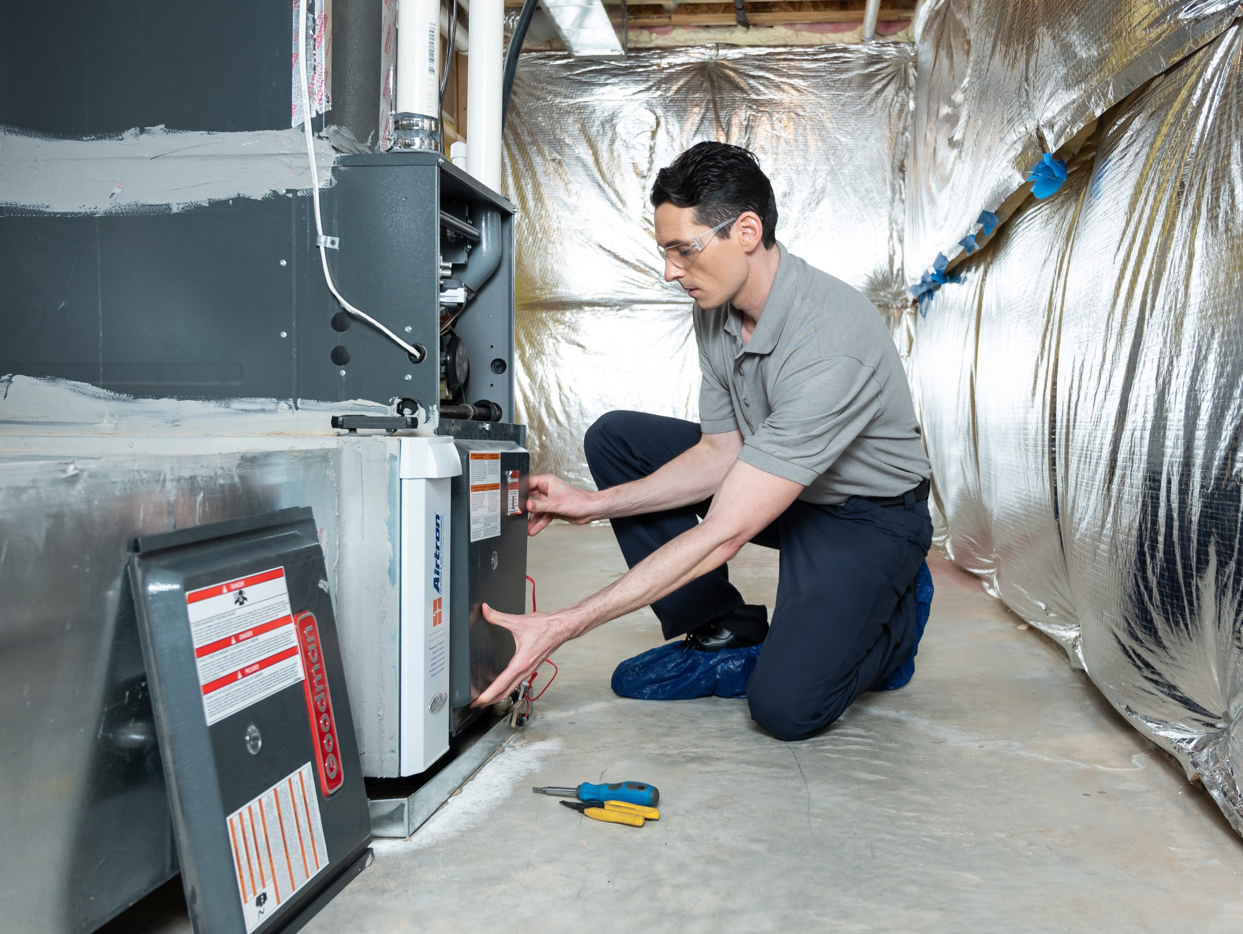 HVAC technician servicing a furnace