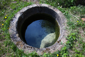 Residential well, surrounded by grass, outside a DMV metro area home.