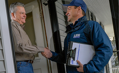 plumber shaking clients hand in Baltimore home